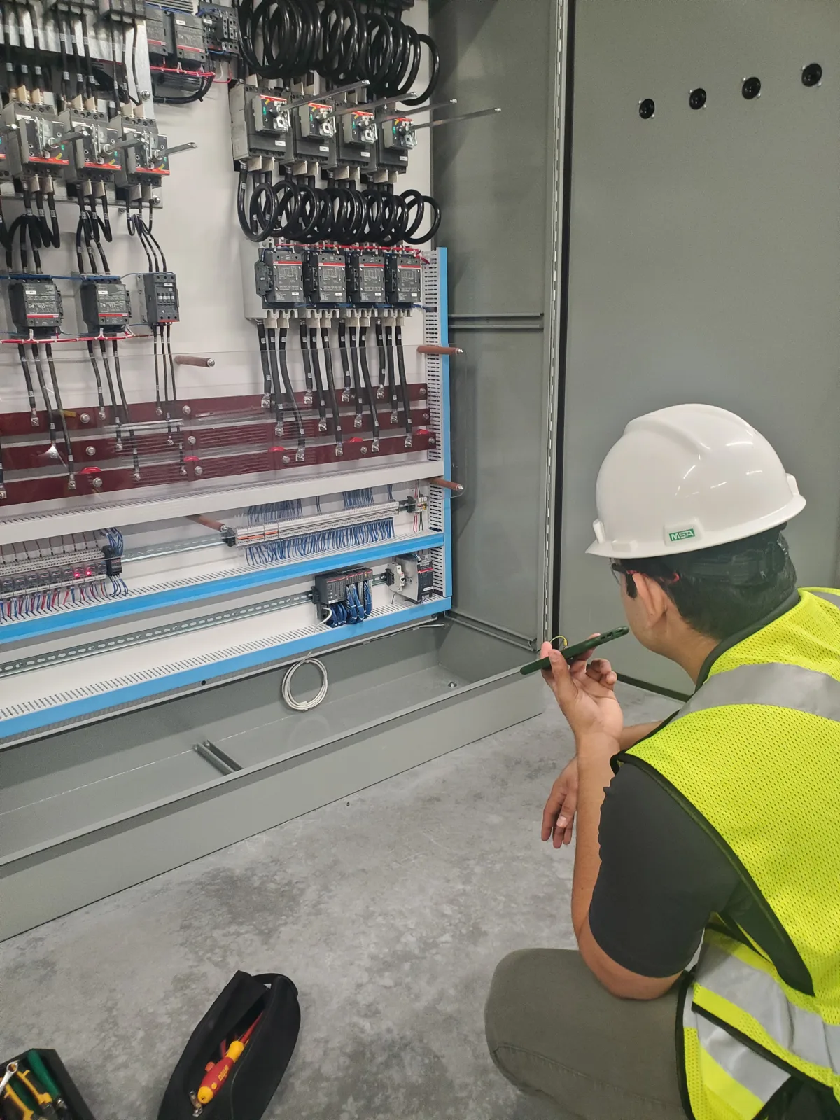 Our engineer commissioning a 690 V multi-drive test panel on site